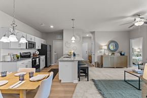 Castle Hayne apartment for rent - A modern kitchen with a dining table set for two.