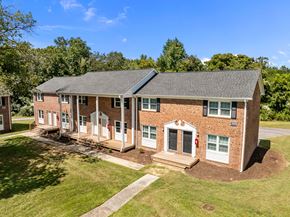 Jacksonville apartment for rent - A red brick building with a black roof and white trim.