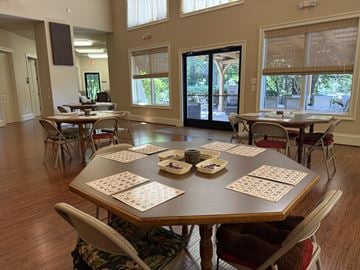 Huntersville triplex for rent - A dining room with a large table set for a game of dominoes.