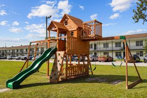 Jacksonville apartment for rent - A wooden playground structure with a green slide.