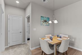 Castle Hayne apartment for rent - A dining room with a wooden table and chairs.