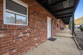 Kernersville apartment for rent - A red brick building with a white door and a window.