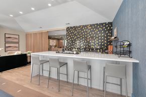 Fayetteville apartment for rent - a kitchen with a white counter top and three stools