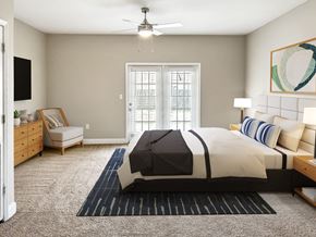 West Columbia townhouse for rent - A bedroom with a large bed and a ceiling fan.