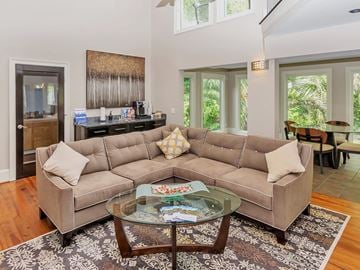 West Columbia townhouse for rent - A living room with a large sectional sofa and a glass coffee table.