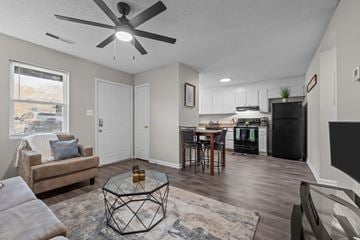 Kernersville apartment for rent - A living room with a brown couch and a glass coffee table.