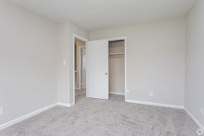 Jacksonville apartment for rent - A white room with a carpeted floor and a doorway leading to another room.