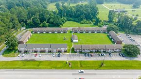 Jacksonville apartment for rent - an aerial view of a building with a field and a parking lot