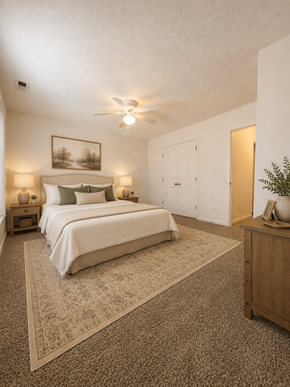 Fuquay-Varina townhouse for rent - A bedroom with a bed, nightstands, and a ceiling fan.