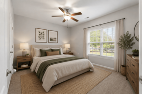 Fayetteville apartment for rent - A bedroom with a large bed and a ceiling fan.