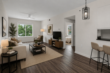 Columbia apartment for rent - A living room with a white couch, a coffee table, and a television.
