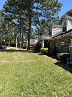 Fuquay-Varina townhouse for rent - A residential area with houses and green grass.