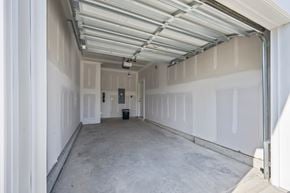 Leland townhouse for rent - A spacious garage with a white ceiling and walls, and a concrete floor.