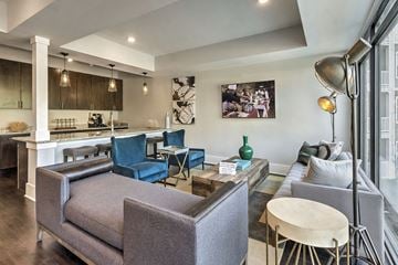 Mount Holly apartment for rent - A modern living room with a grey sofa and a wooden coffee table.