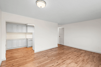 A room with wooden floors and white walls.
