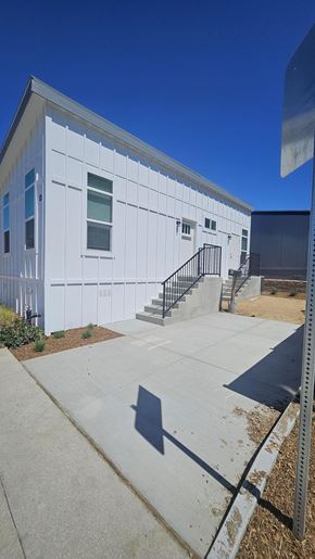 Thousand Oaks apartment for rent - A white building with a black railing on the stairs.