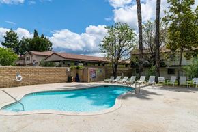 Simi Valley apartment for rent - a swimming pool with chaise lounge chairs and a resort style pool