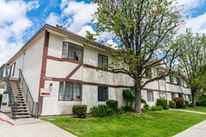 Simi Valley apartment for rent - a white building with a tree in front of it