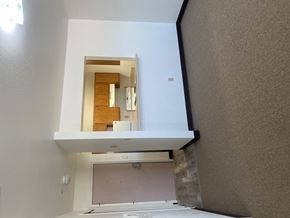 Grants apartment for rent - a view of the bathroom from the living room with the window open