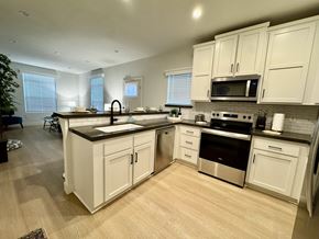 Thousand Oaks apartment for rent - A kitchen with white cabinets and wooden floors.