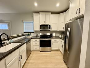 Thousand Oaks apartment for rent - A kitchen with white cabinets and stainless steel appliances.