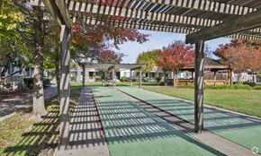 Sacramento apartment for rent - a green pathway with trees and houses in the background