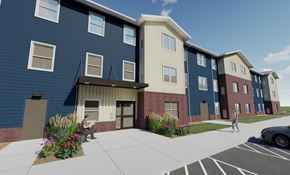 Rapid City apartment for rent - A blue building with a woman walking in front.