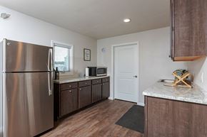 Stoughton apartment for rent - A kitchen with a stainless steel refrigerator and wooden floors.