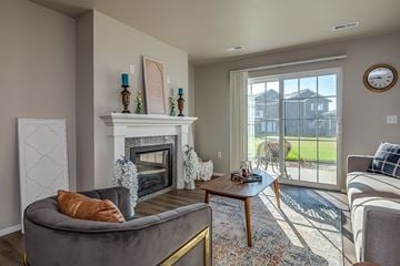 Saukville apartment for rent - A living room with a grey couch and a fireplace.