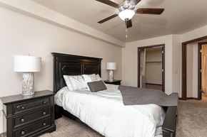 Stoughton apartment for rent - A bedroom with a bed, nightstands, and a ceiling fan.