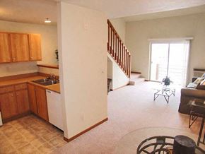Neenah apartment for rent - a kitchen and a living room with a staircase