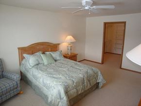 Neenah apartment for rent - a bedroom with a bed and a ceiling fan