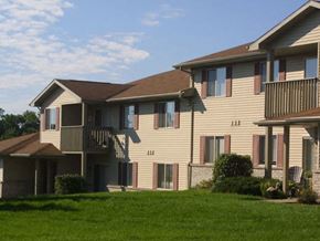 Neenah apartment for rent - a large apartment building with a green lawn
