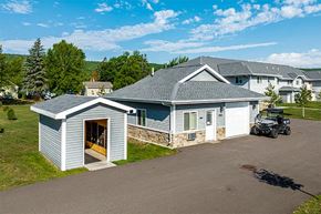Duluth apartment for rent - A house with a garage and a car parked in front.