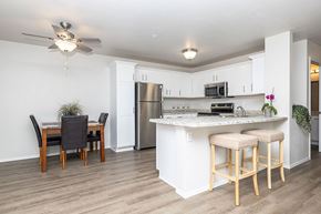 Oshkosh apartment for rent - A kitchen with a bar stool and a dining table.
