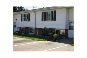 Sturgeon Bay apartment for rent - a white house with black shuttered windows and a driveway
