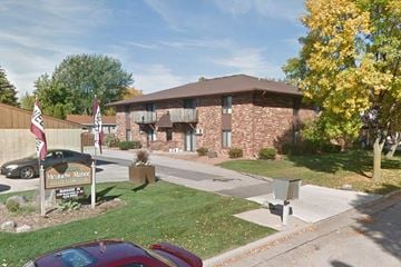 Neenah apartment for rent - a building with an flag in front of it