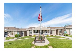 Bismarck apartment for rent - a flag pole with an flag in front of a house