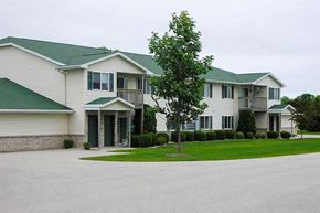 Manitowoc apartment for rent - a large white house with a tree in front of it