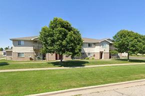 Neenah apartment for rent - an apartment building with green grass and trees