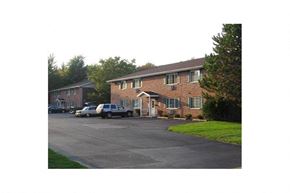 Wisconsin Rapids apartment for rent - a brick house with cars parked in the driveway
