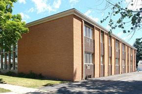 Depere apartment for rent - a brick building with a sidewalk in front of it