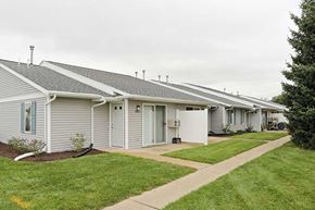Elkhorn apartment for rent - a row of white houses with a sidewalk and grass