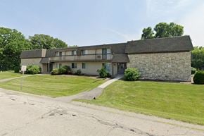 Appleton apartment for rent - a stone house with a green lawn and a sidewalk