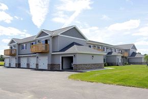 Kronenwetter apartment for rent - A large two-story house with a garage on the ground floor.