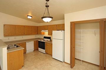 Oshkosh apartment for rent - a kitchen with a white refrigerator and a stove