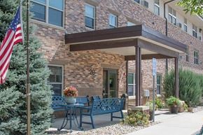 Clear Lake apartment for rent - a patio with a table and benches in front of a brick building