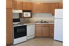 Woodruff apartment for rent - a kitchen with white appliances and wooden cabinets