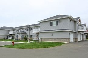 Oshkosh apartment for rent - a row of houses on a street with a fire hydrant