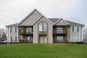 Random Lake apartment for rent - a house with a green lawn in front of it